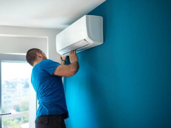New air conditioning unit being installed on a wall